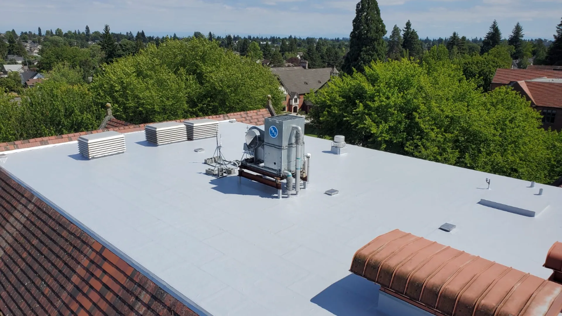 New white TPO flat roof on a multi-unit building