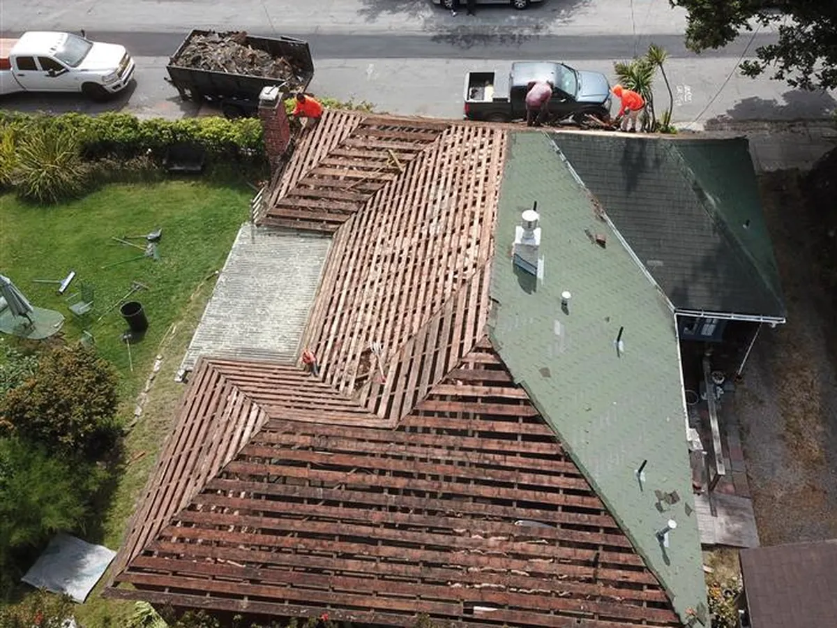 Aerial view of a roof tear-off and deck preparation before a new roof