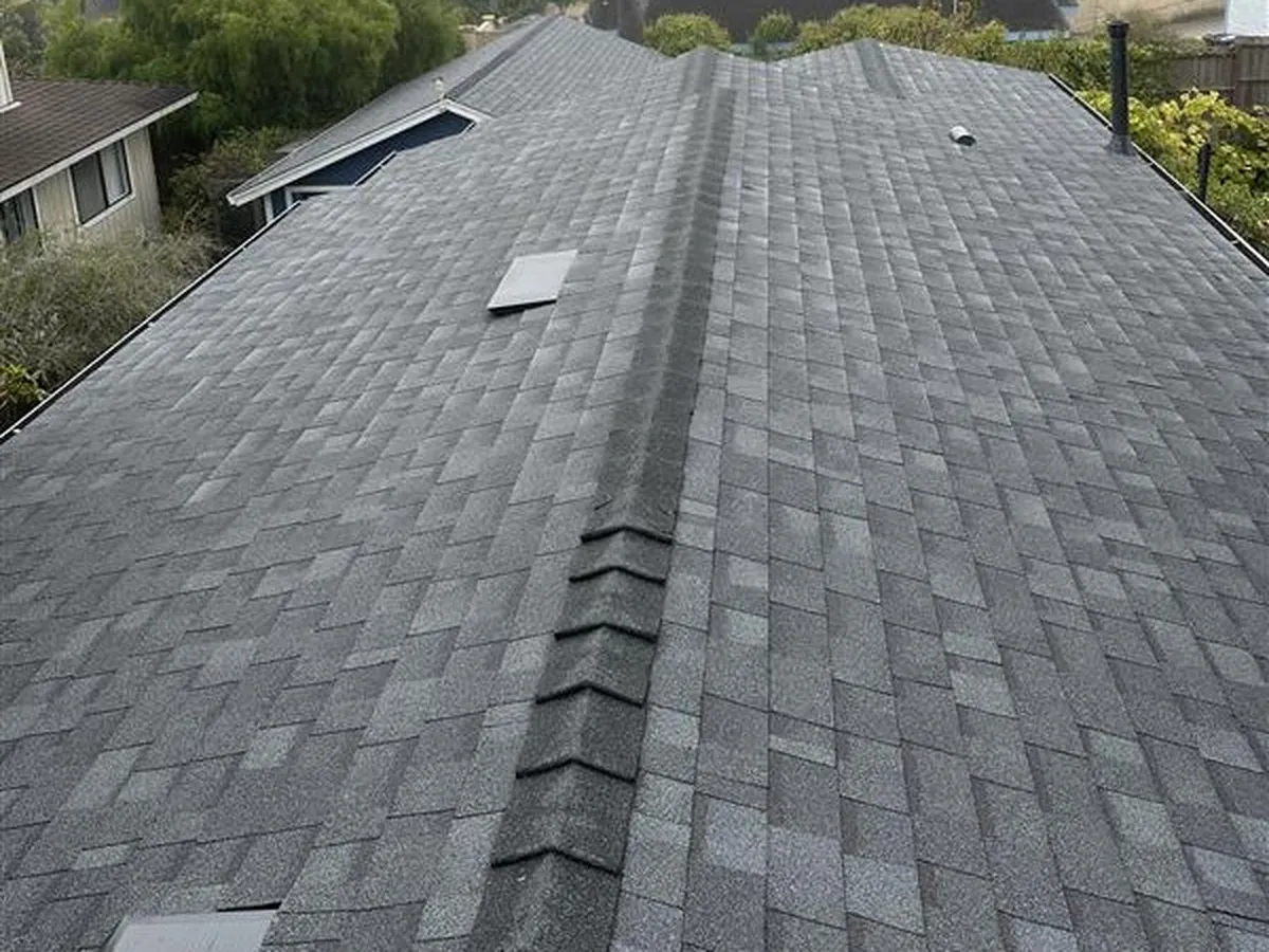 Finished architectural shingle roof replacement with new ridge cap
