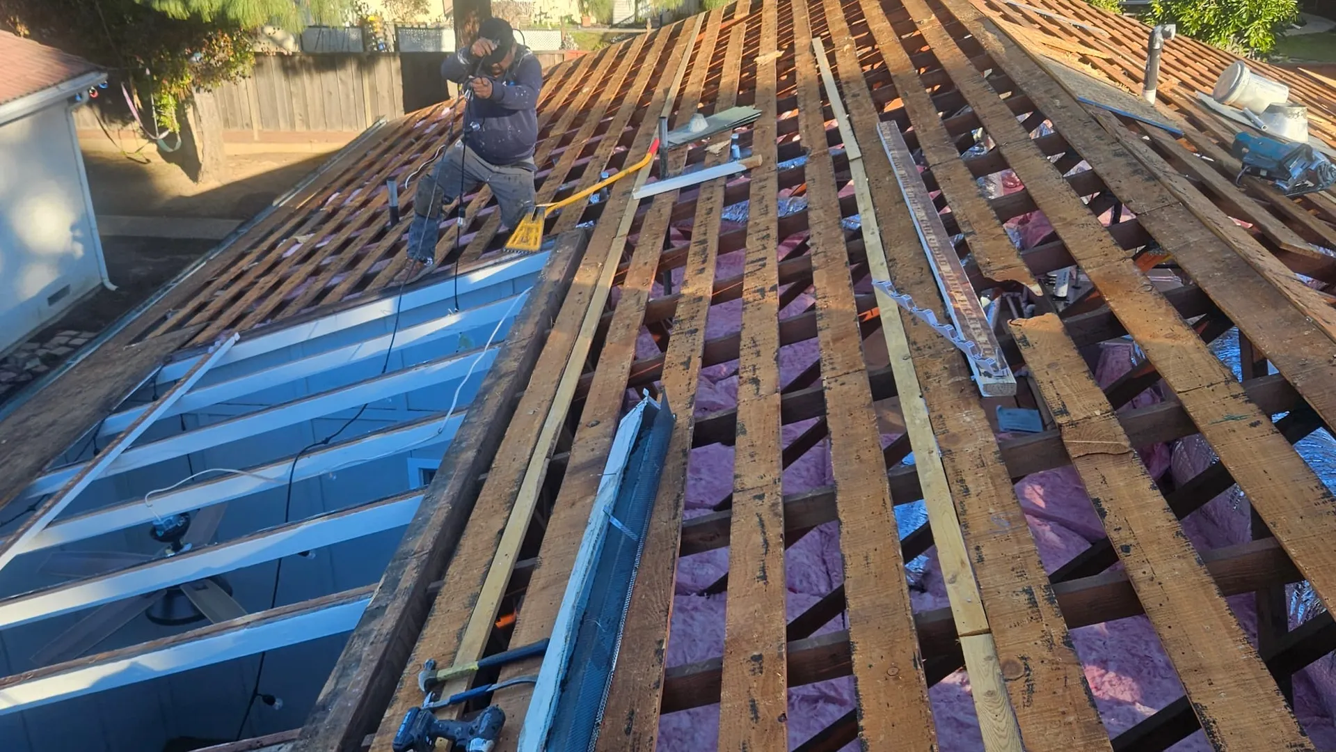 Open roof deck with new insulation during a roofing retrofit
