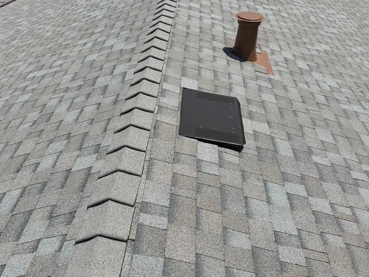 Ridge cap, roof vent and pipe flashing repaired on a shingle roof