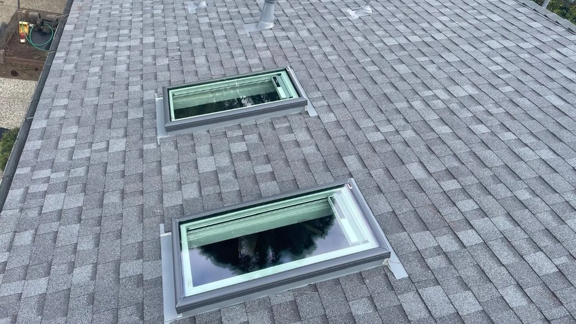 Two new skylights installed in a shingle roof